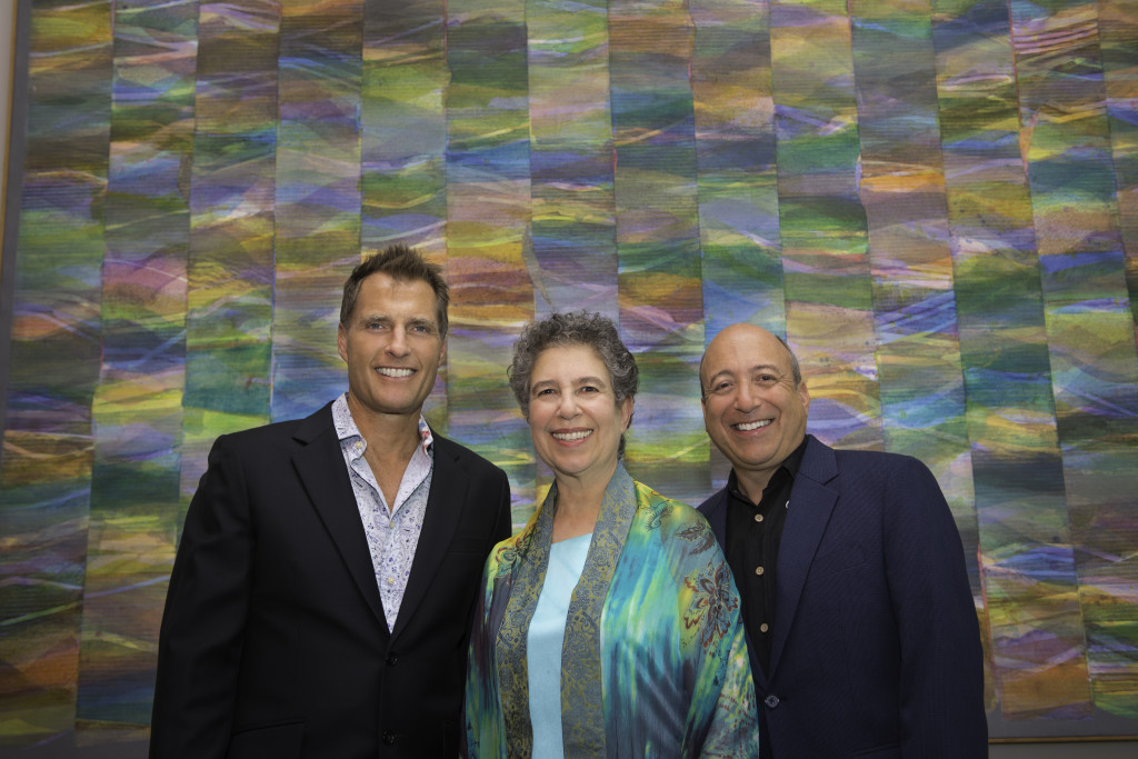 Bill Terwilliger, Meira Warshauer, and Andrew Cooperstock in front of Philip Mullen's "Women in the Country [Series 6 No. 2]" at the Koger Center for the Arts. (photo by Mike Bull)